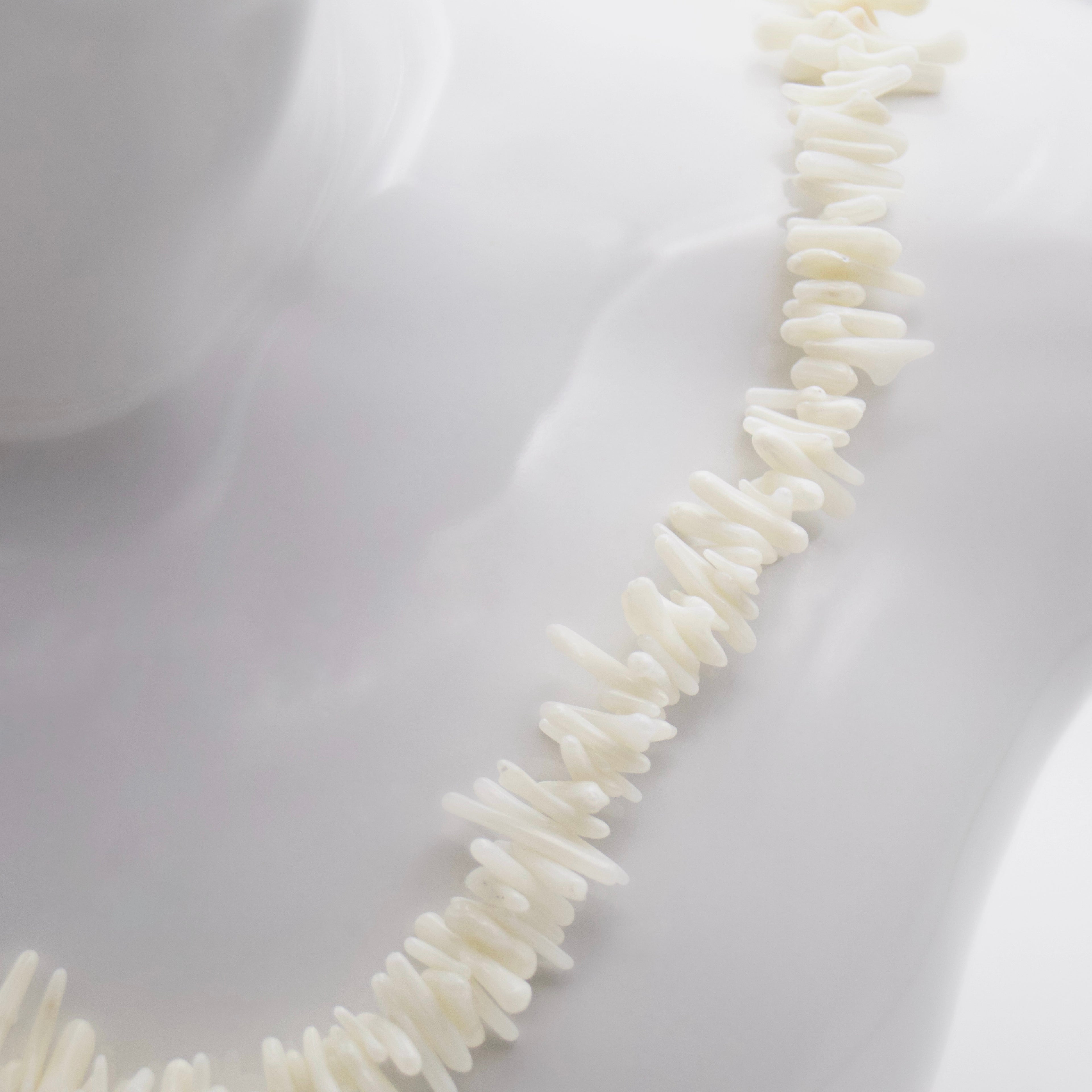 White coral pendant close up. Natural stone texture. Ancient energy jewelry.